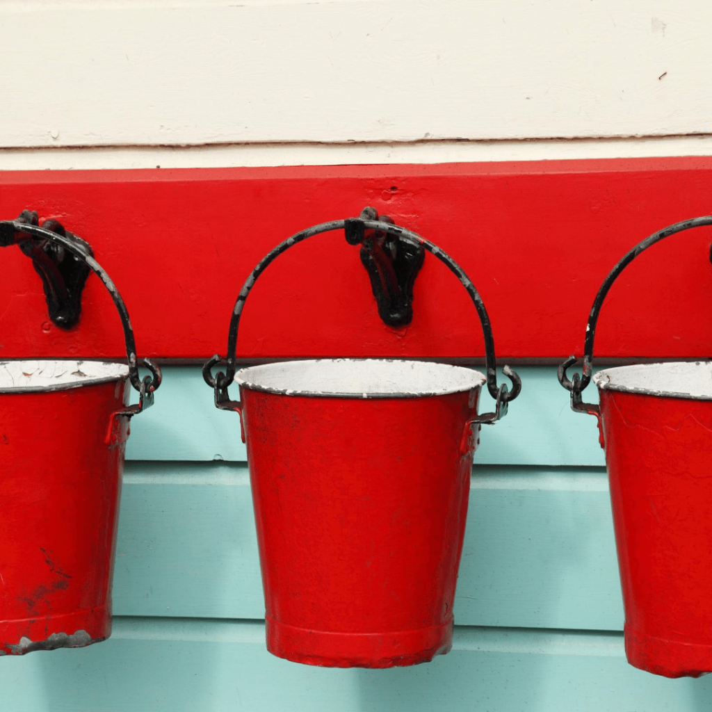 Red buckets hanging from hooks