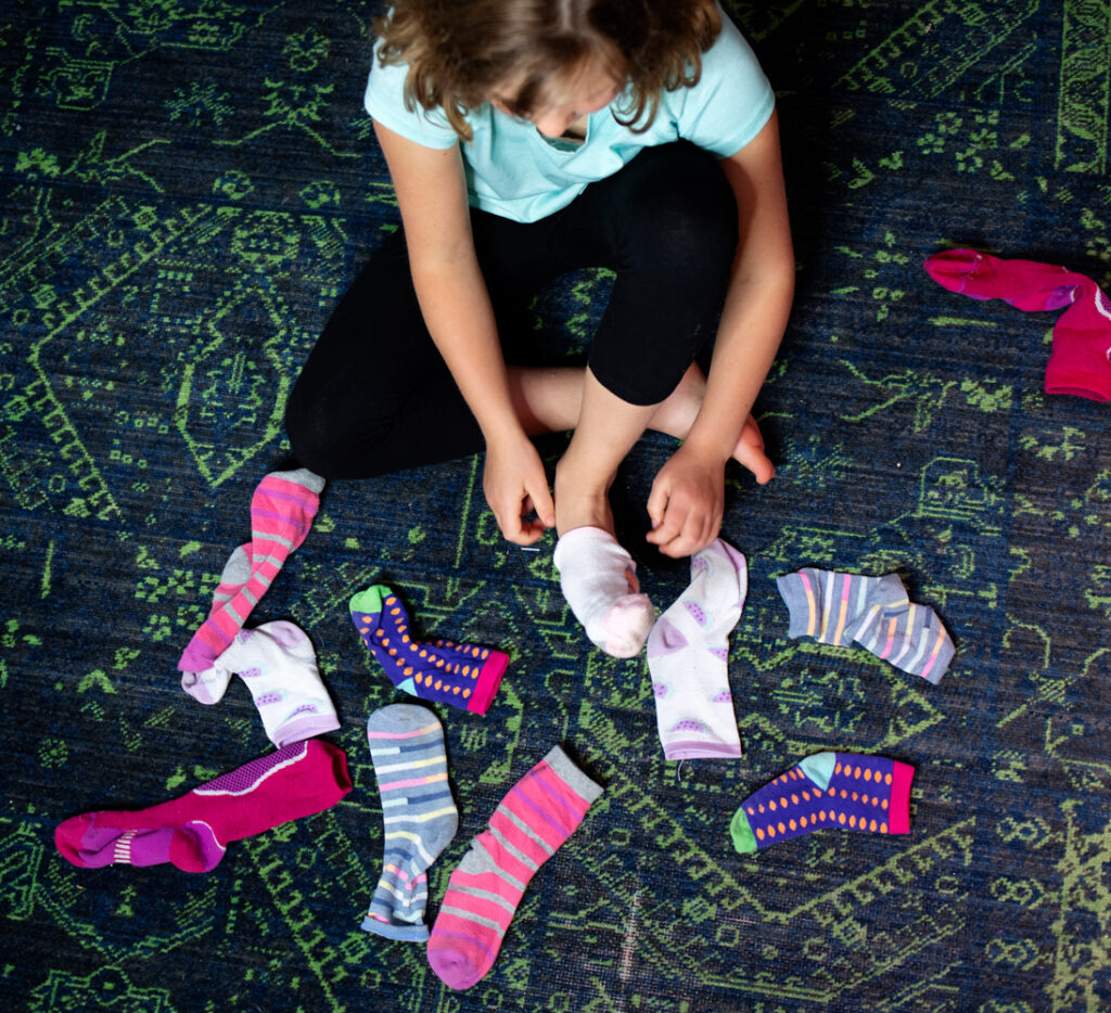 child choosing and putting on socks