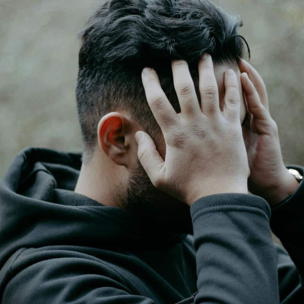 Man holding his head in his hands in distress
